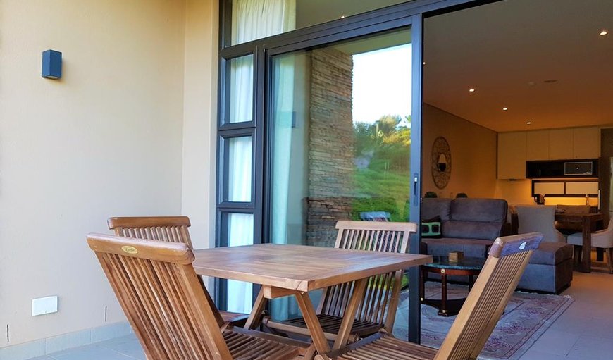 Patio with outdoor furniture and doors leading to the open-plan living/dining and kitchen area in Ballito, KwaZulu-Natal, South Africa