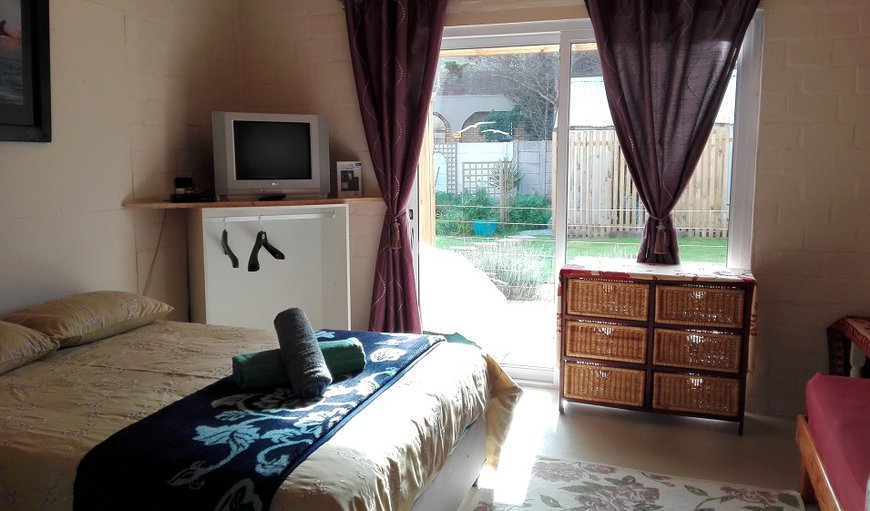 Unit 4: The bedroom is furnished with a double bed and a TV with hotel style DSTV.