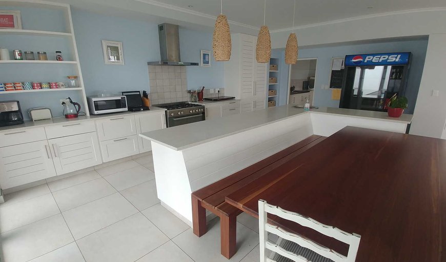 The open plan kitchen is equipped with a fridge/freezer, microwave, hob and oven, cutlery and crockery. The open plan kitchen is equipped with a fridge/freezer, microwave, hob and oven, cutlery and crockery.