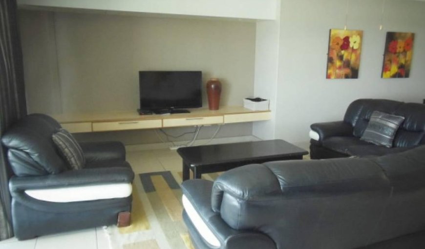 Lounge with comfortable seating and a TV with DStv