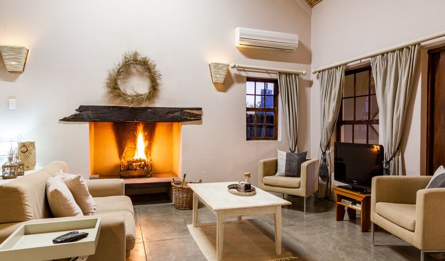 The lounge is tastefully decorated in cool shades of white and grey with a fireplace and flat screen TV. The lounge is tastefully decorated in cool shades of white and grey with a fireplace and flat screen TV.