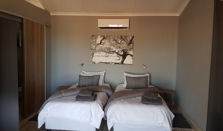 Moringa Tree: Jansen Kalahari Guest Farm bedroom with single beds.