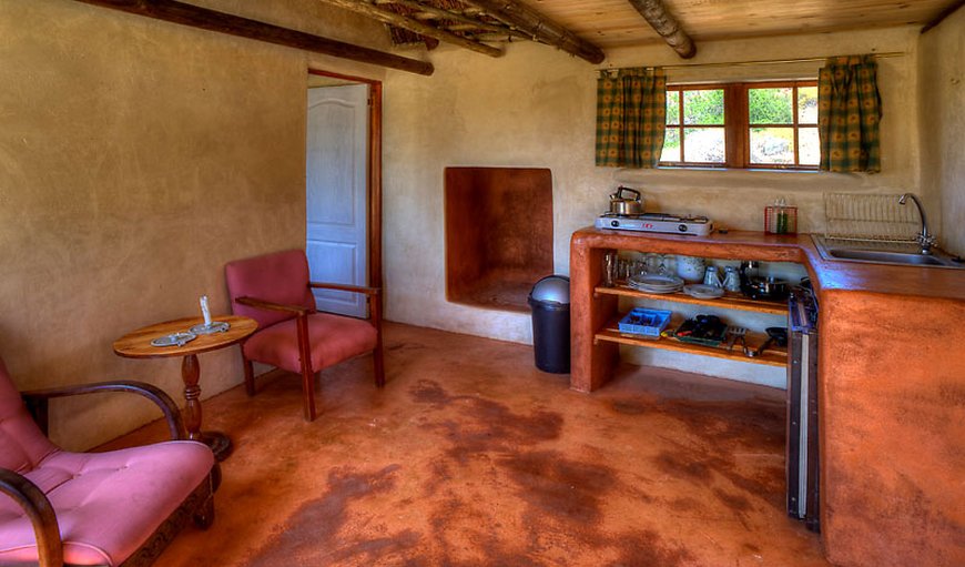 Lonely Planet Cottage: Open-plan lounge and kitchenette fitted with a gas stove