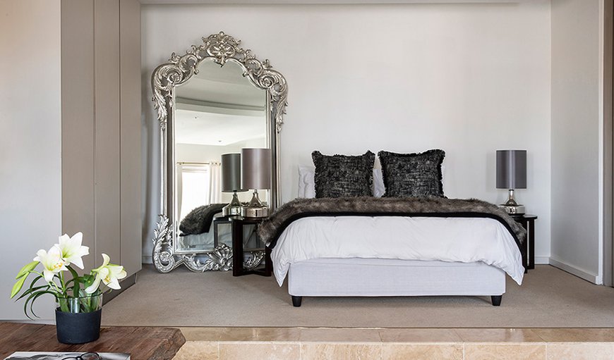 The Franklin Apartment 1512: Sleeping area with oversized, elaborately framed, full-length mirror.