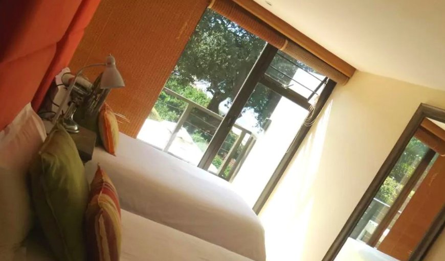 Bedroom 3 with twin single beds and glass doors that open up completely to the wooden deck overlooking the beach, jacuzzi and garden area. Bedroom 3 with twin single beds and glass doors that open up completely to the wooden deck overlooking the beach, jacuzzi and garden area.
