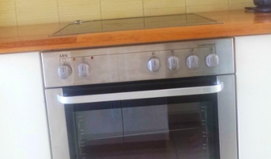 The kitchen is equipped with a fridge/freezer, a microwave, an oven and stove, and cutlery and crockery, as well as a washing machine for guest’s convenience. The kitchen is equipped with a fridge/freezer, a microwave, an oven and stove, and cutlery and crockery, as well as a washing machine for guest’s convenience.