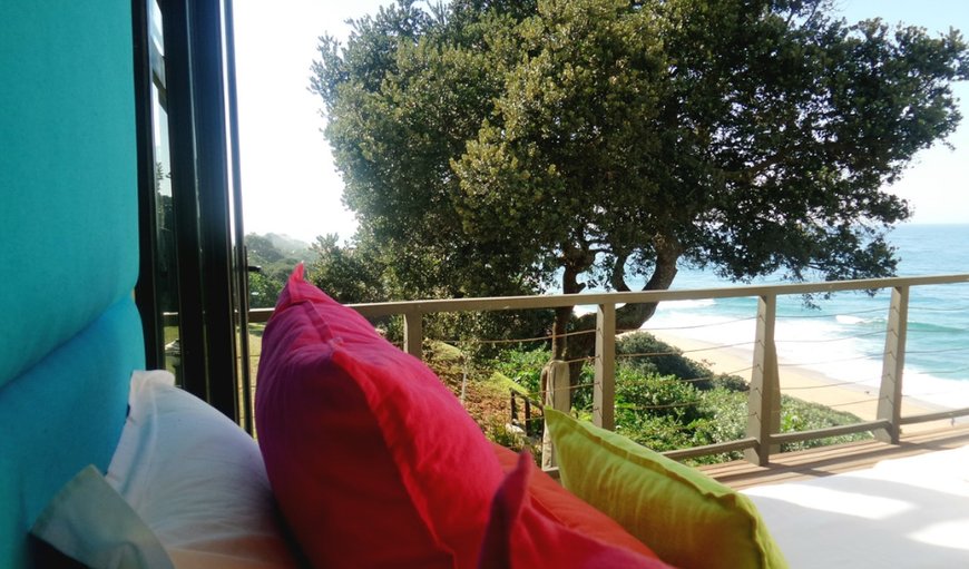 Bedroom 1 with king size bed and glass doors that open up completely to the wooden deck overlooking the beach, jacuzzi and garden area. Bedroom 1 with king size bed and glass doors that open up completely to the wooden deck overlooking the beach, jacuzzi and garden area.