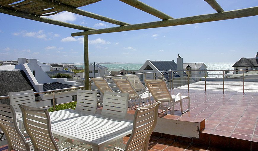 The large balcony features deck chairs, a dining area and spectacular views in Arniston, Western Cape, South Africa
