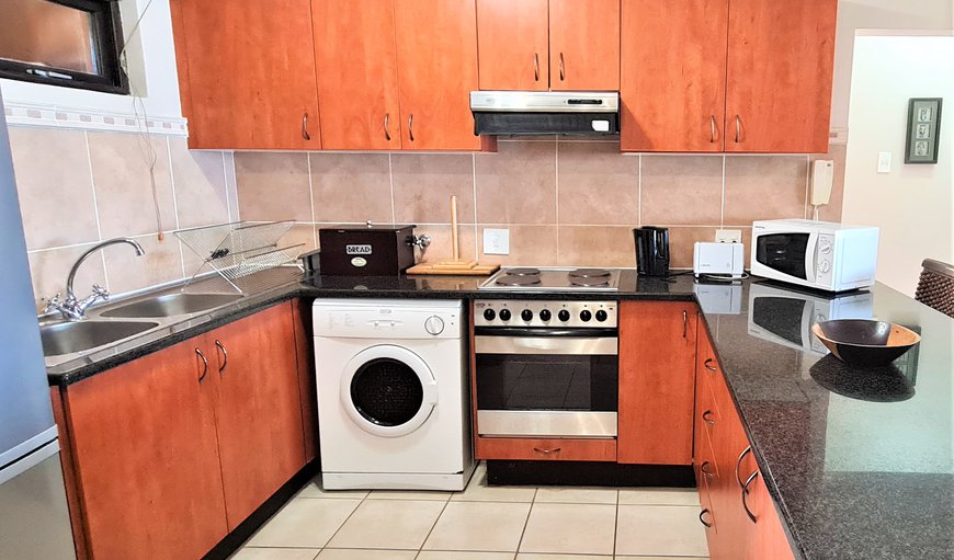 Fully equipped kitchen with fridge/freezer, oven and stove, kettle, toaster, microwave and tumble drier