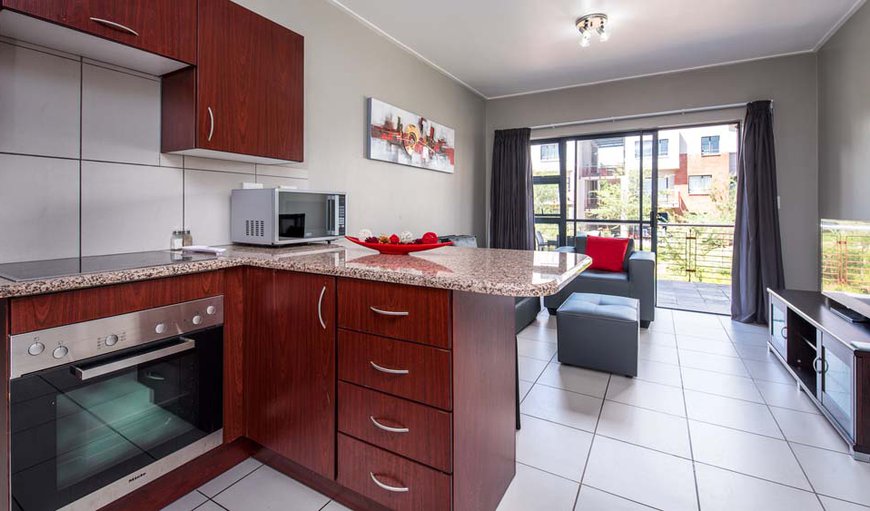 The kitchen is fully equipped with a washing machine and tumble dryer in Roodepoort, Gauteng, South Africa