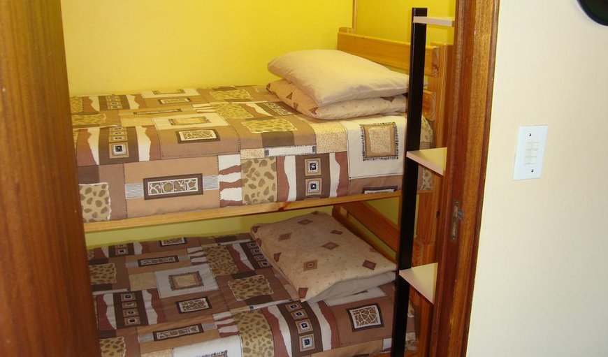 Family Room: Family Room - The family room is located upstairs consisting of three single beds and another adjoining doublebunk-bed room, as well as a colour remote TV with MNet, coffee/tea making facilities and an en-suite bathroom.