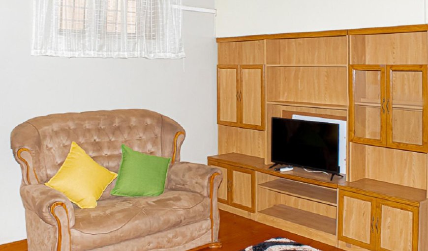 Unit 1 - The lounge area is furnished with comfortable couches and a TV