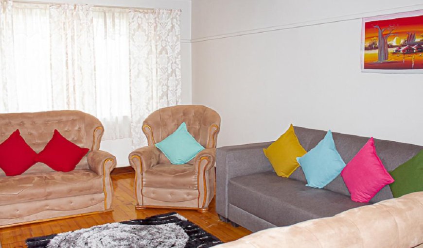 Unit Three: Unit 3 - The lounge area is furnished with comfortable couches and a TV