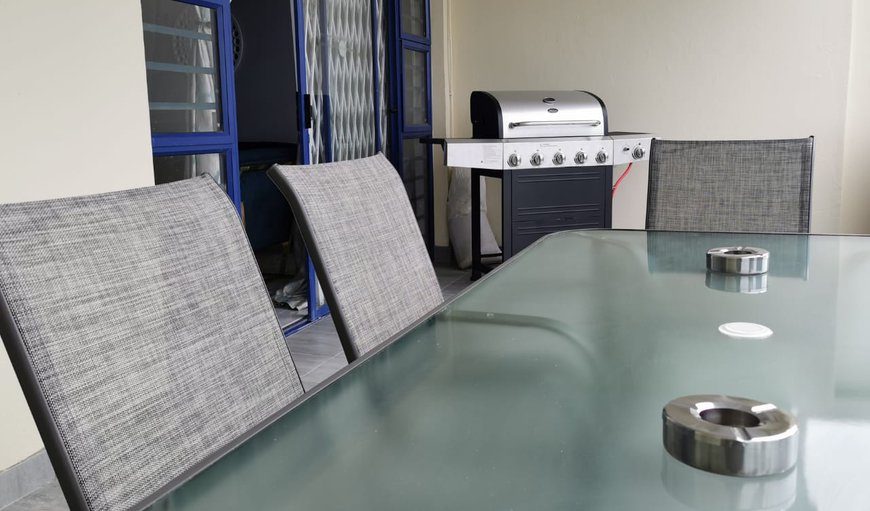 The apartment features a patio with a gas braai