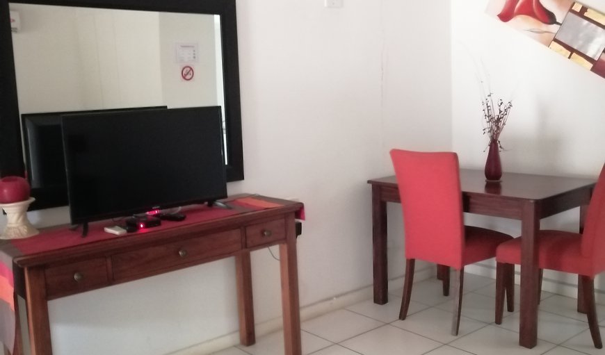 Crane: Crane Cottage - The open plan area has a double bed, a TV and a little dining table with chairs