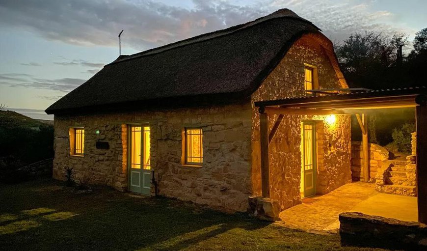 Cottage lit up at night in Vermaaklikheid, Western Cape, South Africa