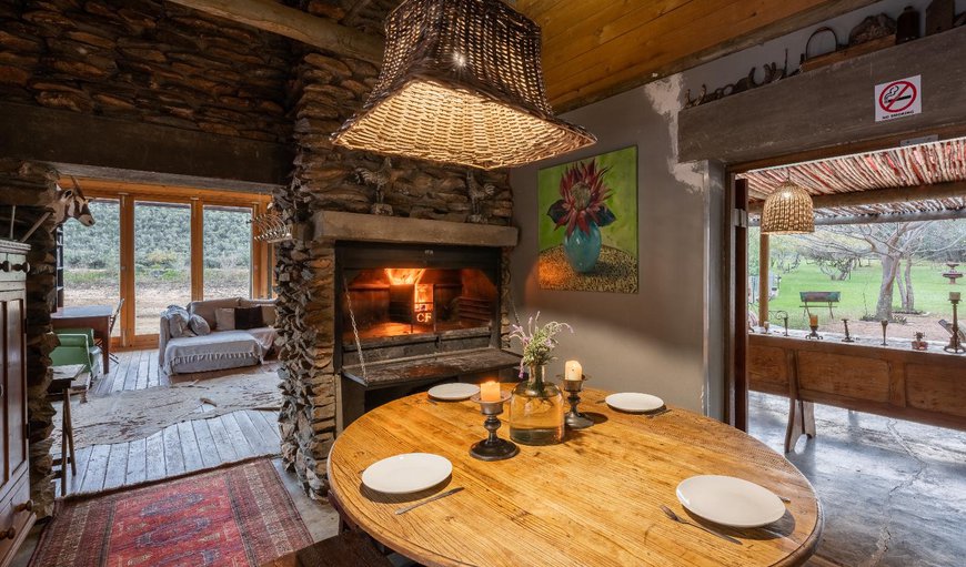 The main entertainment area is situated over the dam with uninterrupted views of the Swartberg Mountains. It offers open plan indoor and outdoor living areas with a traditional dover stove The main entertainment area is situated over the dam with uninterrupted views of the Swartberg Mountains. It offers open plan indoor and outdoor living areas with a traditional dover stove