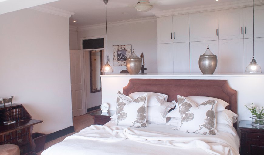 Self Catering House: Master Bedroom - This ocean-facing room is ensuite and has a walk-in closet, double bed, TV, shower, bath (With sea views) and his + her basins