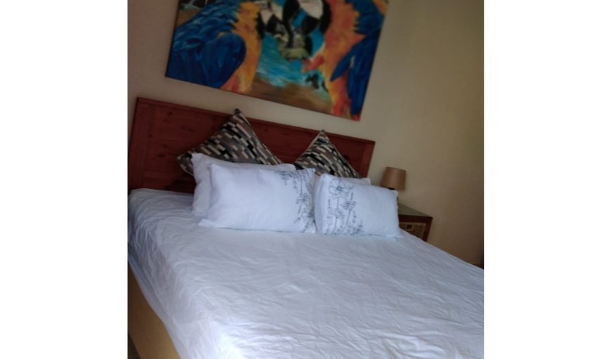 Whale Rock 15: The main bedroom contains a double bed and an en-suite bathroom fitted with a bath and a shower, a toilet and washbasin
