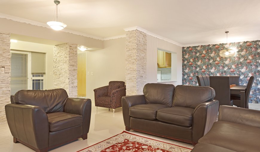 The ground floor features a spacious open plan design lounge with a built-in fireplace and a large wall-mounted flat-screen TV The ground floor features a spacious open plan design lounge with a built-in fireplace and a large wall-mounted flat-screen TV