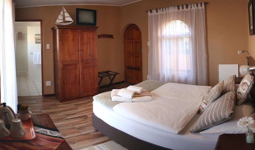 Double Room: Captains Cabin bedroom with  en-suite bathrooms, DSTV, hairdryer, tea and coffee making facilities, soap and shower gel, heating, fans and their own entrance laid to the tranquil courtyard, equipped with sundeck chairs and umbrellas.