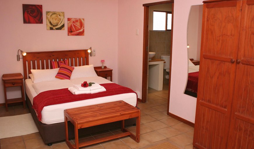 Cottage: Rose's Room bedroom with  en-suite bathrooms, DSTV, hairdryer, tea and coffee making facilities, soap and shower gel, heating, fans and their own entrance laid to the tranquil courtyard, equipped with sundeck chairs and umbrellas.