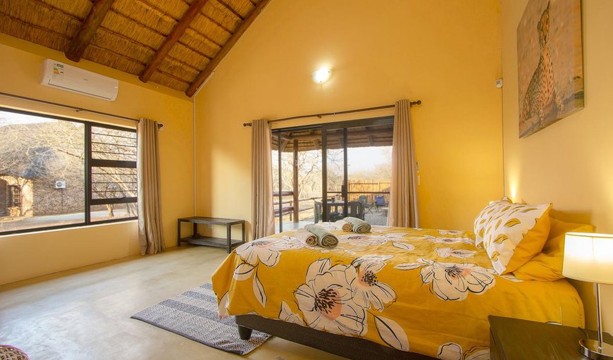 Bedroom 1 has 1 x queen bed and 1 x 3/4 bed and is en suite with a shower in Marloth Park, Mpumalanga, South Africa