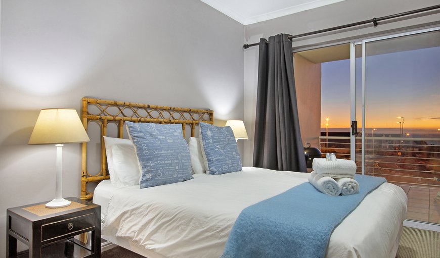 Dolphin Ridge 108: The main bedroom features a queen bed, a private balcony with stunning ocean and mountain views
