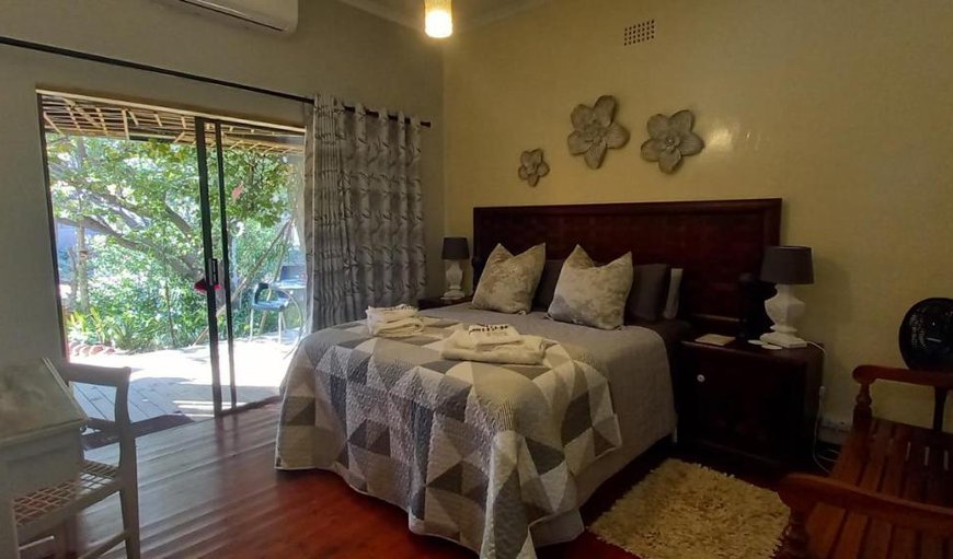 Room with Patio: Bedroom with a queen size bed