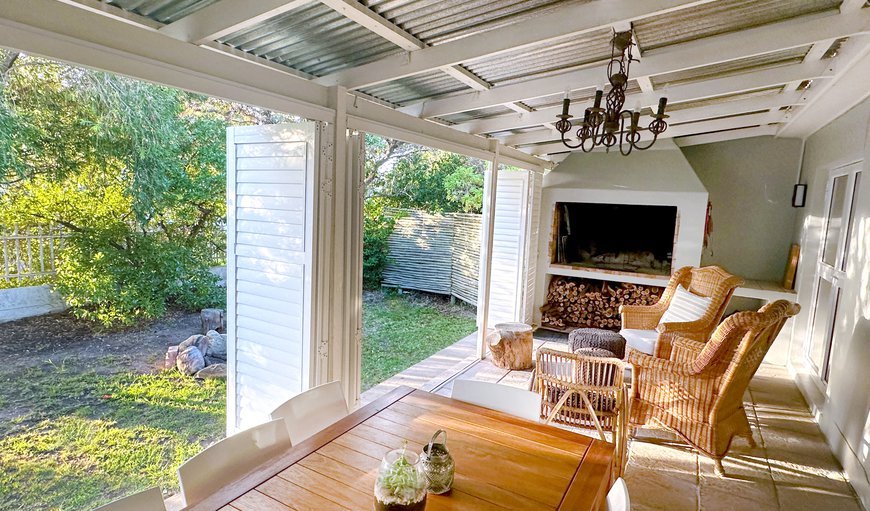The dining area is right off the lounge, with a barbecue / fireplace with firewood provided and an 8-seater table. It also opens out onto the garden. The dining area is right off the lounge, with a barbecue / fireplace with firewood provided and an 8-seater table. It also opens out onto the garden.