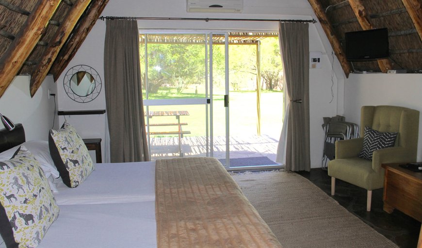 Standard Self Catering Chalet - The chalet offers two x ¾ beds downstairs by the sliding door leading out to the patio. Standard Self Catering Chalet - The chalet offers two x ¾ beds downstairs by the sliding door leading out to the patio.