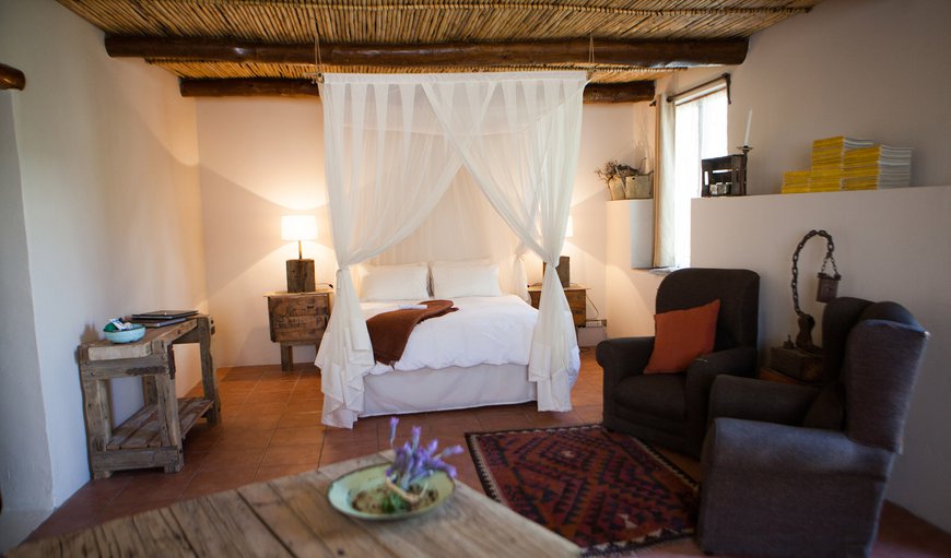 Cottage 1: Four poster elegance, with rustic Karoo touches. This image is taken from the kitchonette.
