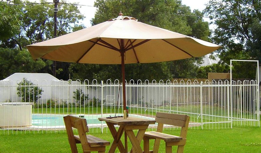 Garden with swimming pool and seating area